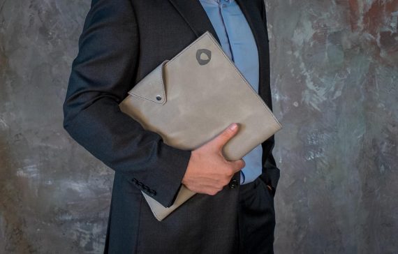 man holding grey leather padfolio