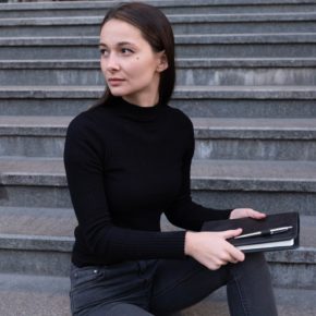 woman with black notebook